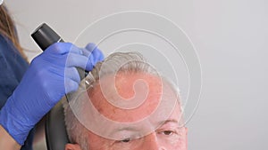 An elderly man visits a trichologist. Hair loss problem