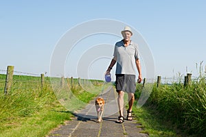 Elderly man walking the dog