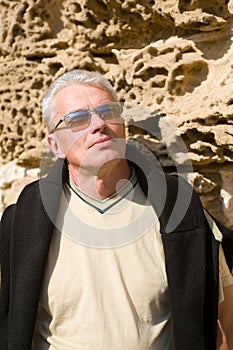 Elderly man at wall