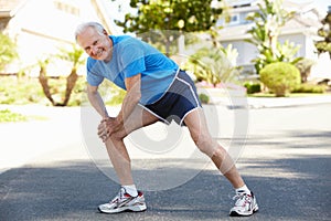 Elderly man warming up for run