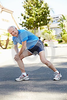 Elderly man warming up for run