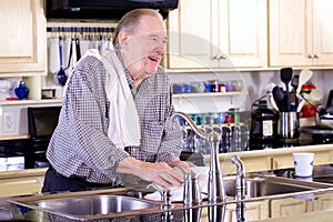 Elderly man washing dishes