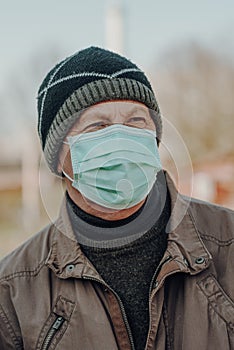 Elderly man wearing facial mask to prevention of infection