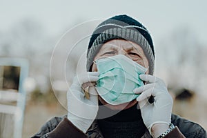 Elderly man wearing facial mask to prevention of infection