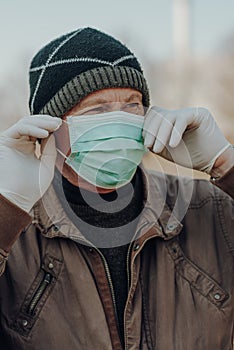 Elderly man wearing facial mask to prevention of infection