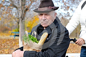 Elderly man in a wheelchair grocery shopping