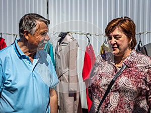 Elderly man and woman communicate in the market