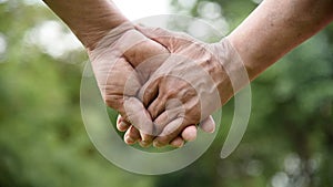 Elderly man and woman exercising at park outdoor together