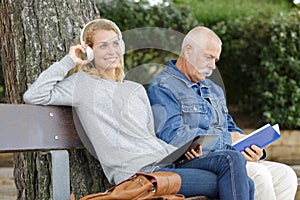 Elderly man and woman on park bench