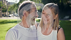 Elderly Man And Woman In Park After Fitness Talk And Have Fun. They Smile. Gray Haired Man With Beard And Woman With