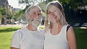 Elderly Man And Woman In Park After Fitness Talk And Have Fun. They Smile. Gray Haired Man With Beard And Woman With
