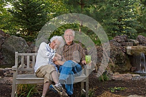 Elderly man and woman sitting on a bench