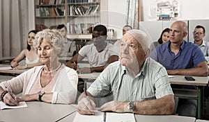 Elderly man and woman take a written exam