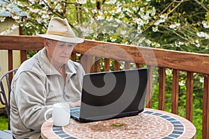 Elderly Man Working on Laptop Computer photo