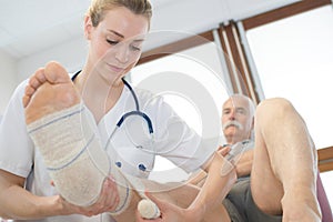 elderly man on leg therapy