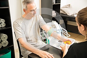 Man Receiving Electrotherapy From Therapist photo