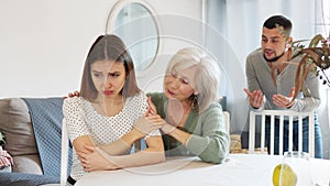 Elderly mother comforts her adult daughter after her quarrel with her husband