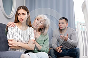 Elderly mother comforts her adult daughter after her quarrel with husband