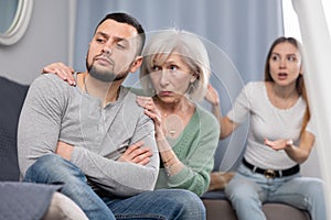 Elderly mother comforts her son after his quarrel with his wife