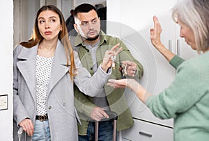 Elderly mother takes the keys and kicks the young couple out of apartment photo