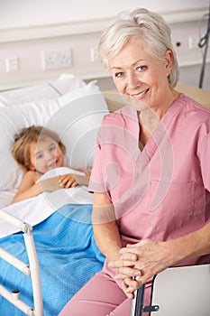 Elderly nurse in USA pediatrics with child patient photo