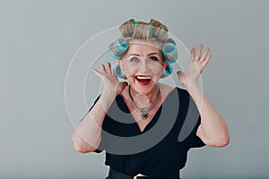 Elderly old aged woman housewife with curlers rollers on hair head