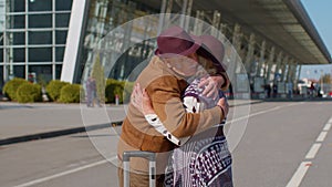 Elderly old husband wife retirees tourists reunion meeting in airport terminal after long separation