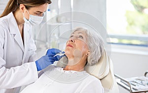 Elderly patient getting lip fillers.