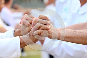 Elderly patient people join hand together and support each other to encourage good health life