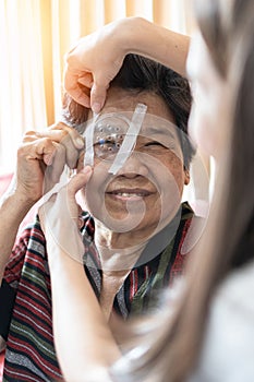 Elderly patient woman having eye care treatment on Age-related eye diseases, AMD, Diabetic retinopathy, Glaucoma, low vision photo