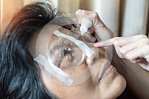 Elderly patient woman having eye drop care on Age-related eye diseases, AMD, Diabetic retinopathy, Glaucoma, low vision, dry eyes