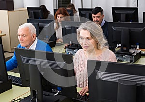 Elderly people attending pc class