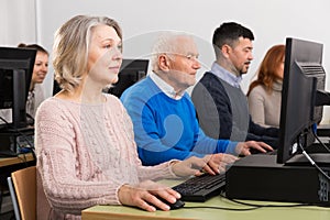 Elderly people attending pc class