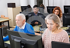 Elderly people attending pc class