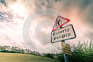 elderly people crossing road warning sign
