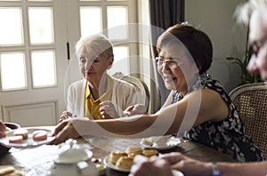 Elderly people having tea party together