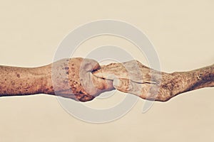 Elderly people holding hands together