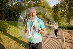 Elderly people jogging, sports activities for senior man and woman