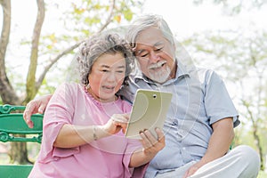 Elderly people lifestyles and communication technology. Happy grandparent using tablet video call and talking with family.