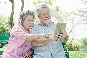 Elderly people lifestyles and communication technology. Happy grandparent using tablet video call and talking with family.