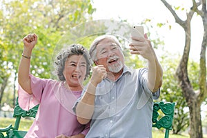 Elderly people lifestyles and communication technology. Happy grandparent using tablet video call and talking with family.
