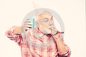 Elderly people. Man bearded grandpa with birthday cap and drink cup. Birthday crazy party. Ideas seniors birthday