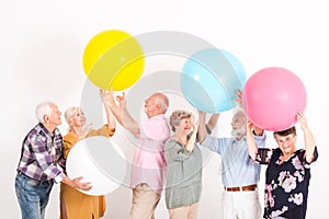 Elderly people playing with big balls in room