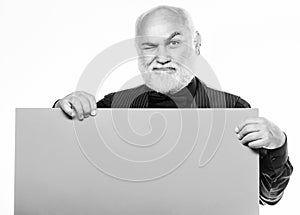 Elderly people. Senior holding blank sign board and looking at camera. Man bold head and gray beard hold poster for