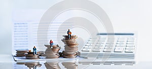 Elderly people sitting on coins stack.