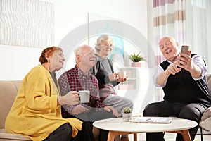 Elderly people spending time together in room