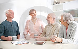 Elderly people spending time together at table