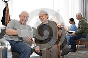 Elderly people with tablet in hospice. Senior people care