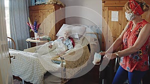 Elderly person being cared for by care worker.