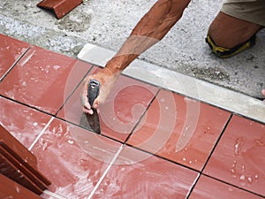 Elderly person intent on instiling and linear tiles